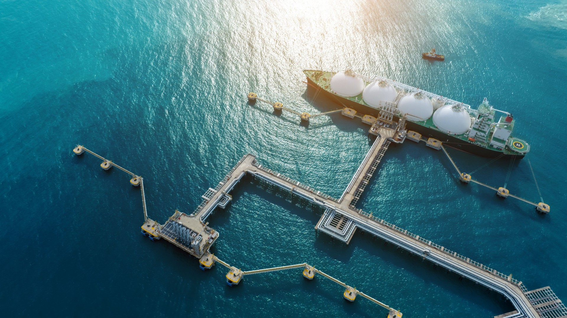 LNG (Liquified Natural Gas) tanker anchored in Gas terminal gas tanks for storage. Oil Crude Gas Tanker Ship. LPG at Tanker Bay Petroleum Chemical or Methane freighter export import transportation and logistics