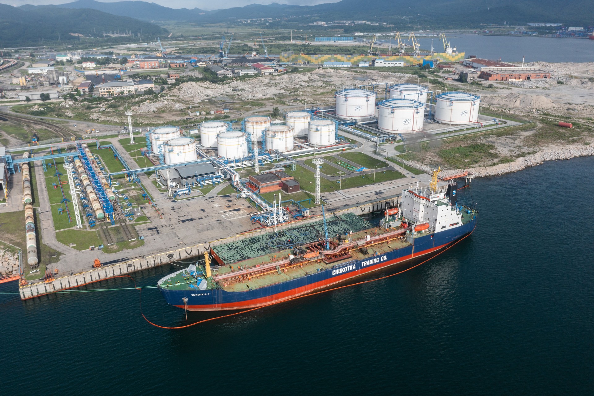 Top view on Oil-storage tank with the tanker at a mooring.
